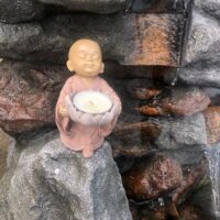 Bébé bouddha rose bougie dans fleur de lotus - Boutique ésotérique La Porte des Secrets